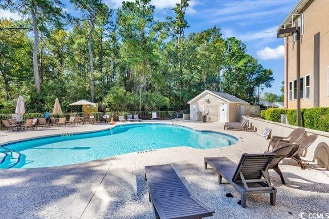 View of swimming pool featuring an outbuilding and a patio area | Image 38