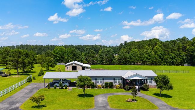 Aerial view of property and surrounding area featuring a heavily wooded area | Image 13