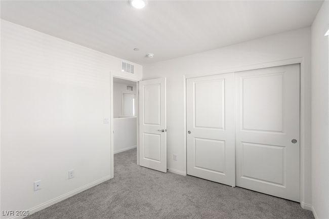 Unfurnished bedroom with a closet, carpet flooring, baseboards, and visible vents | Image 25