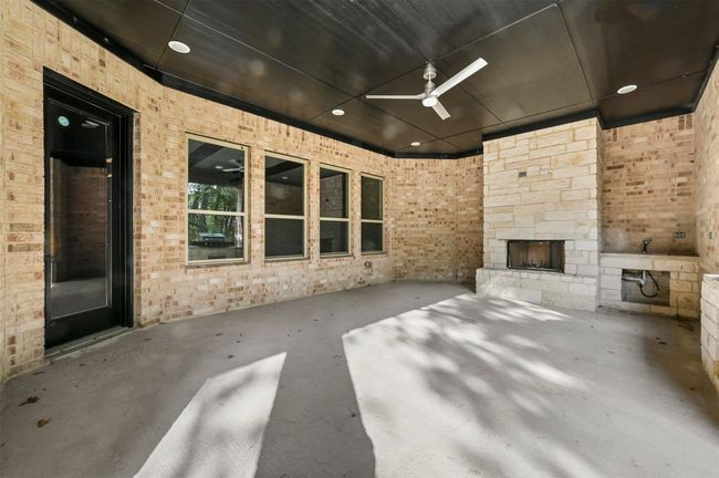 View of patio / terrace featuring ceiling fan and a fireplace | Image 15