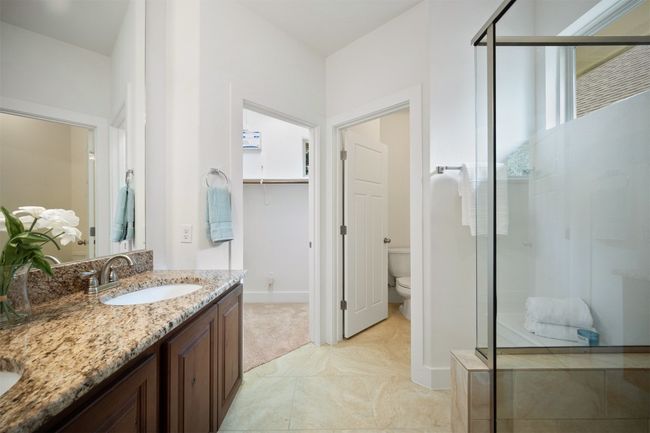 The dual vanity and step-in shower in the ensuite bath bring a sense of openness and ease, providing a well-designed space where getting ready feels like a breeze | Image 22