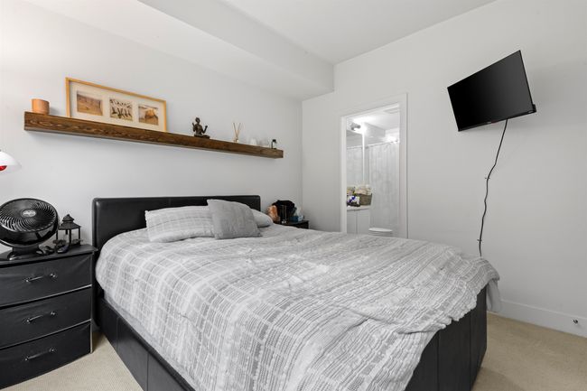 Bedroom featuring light colored carpet and connected bathroom | Image 30