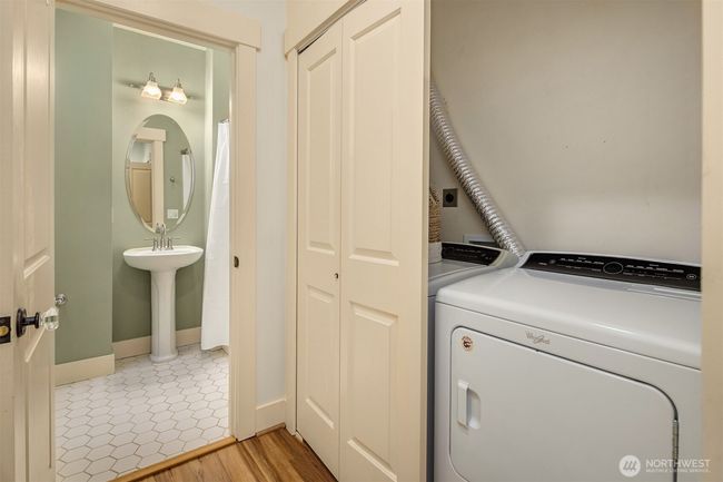 The full-size washer and dryer closet is conveniently situated in the hall, providing easy access for both bedrooms, making laundry a breeze. | Image 18