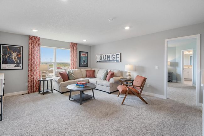 Relax, play and enjoy! This upper-level game room provides an additional 270 square feet of living space and is conveniently located adjacent to all four upper-level bedrooms. Model photo. Options and colors will vary. | Image 14