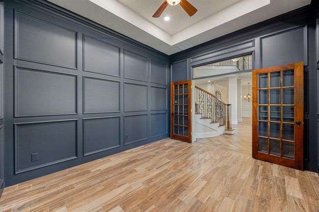 Wooden double doors for privacy in this large private home office. | Image 18