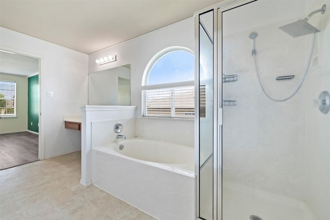 Bathroom with a shower stall, plenty of natural light, and a garden tub | Image 25