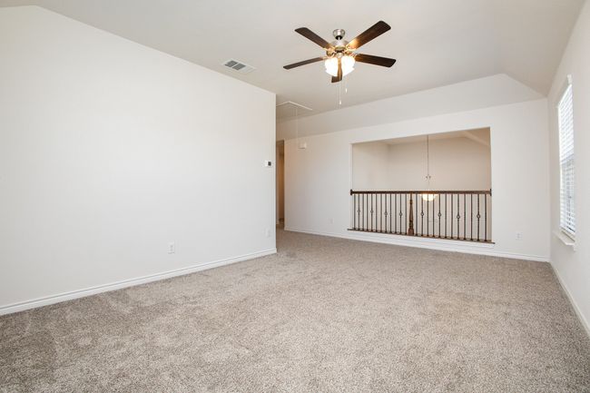 Spare room with carpet, visible vents, attic access, and ceiling fan | Image 21