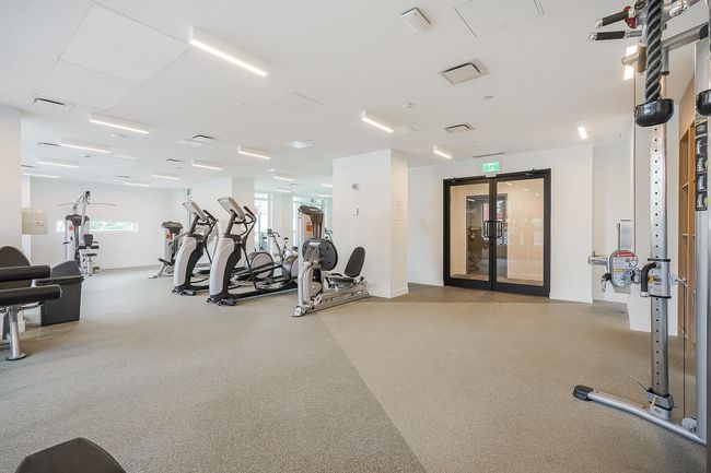 Exercise room with baseboards, visible vents, and a wealth of natural light | Image 32