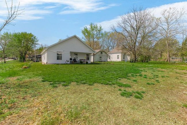Rear view of property featuring a yard | Image 30