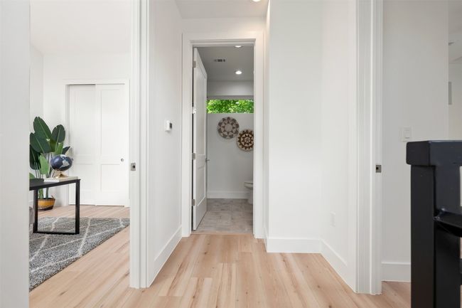 Hallway featuring light wood finished floors and baseboards | Image 20