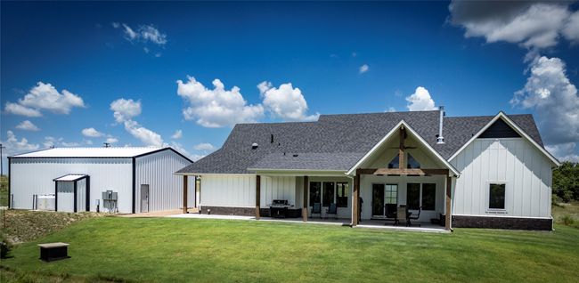 Rear view of house with a yard, a patio area, and an outdoor structure | Image 39