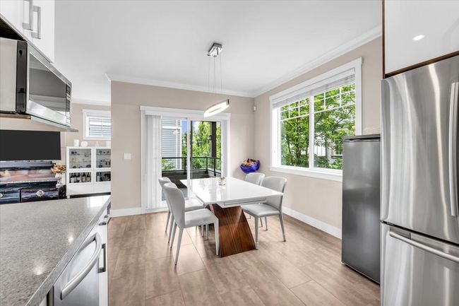 Dining space with crown molding and plenty of natural light | Image 9