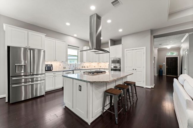 Large kitchen island and upgraded vent hood. Plenty of room for bar stools | Image 8