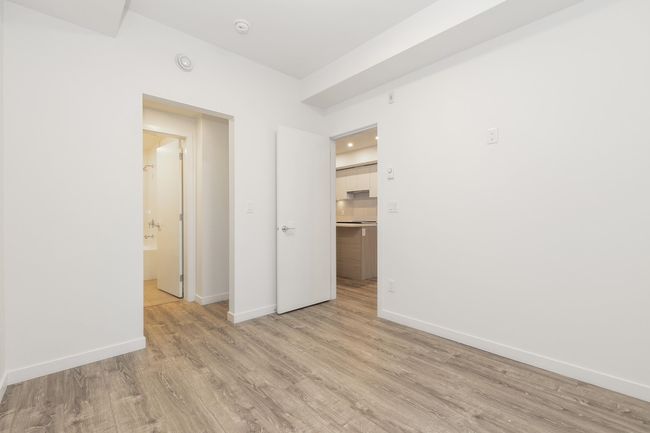 Empty room featuring light wood-style floors, baseboards, and a smoke detector | Image 13