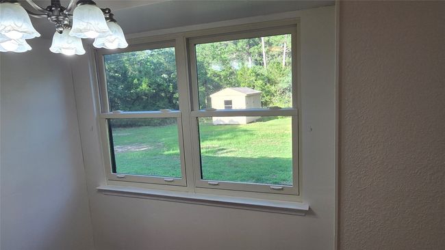 Upgraded window that looks out into the backyard with storage shed. | Image 23