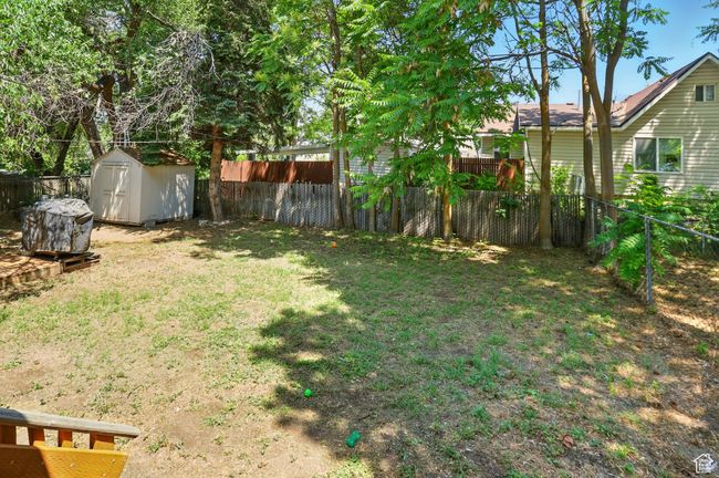 Fenced backyard with a shed | Image 29
