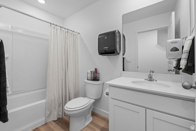 Bathroom with vanity, wood finished floors, and shower / bath combo with shower curtain | Image 4
