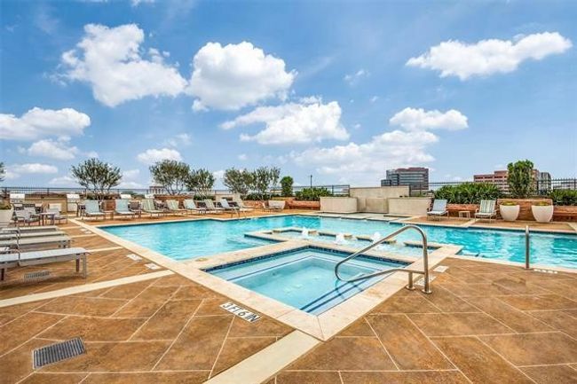 The pristine rooftop pool and spa offer the perfect escape—whether you're looking to swim laps, soak up the sun, or unwind after a long day. Residents can also enjoy private cabanas with plush, comfortable seating, creating a true resort-style experience high above the city. | Image 36