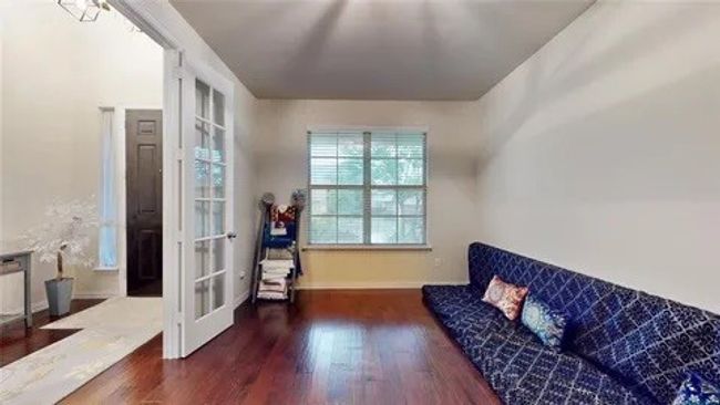 Living area with dark wood-type flooring and french doors | Image 5
