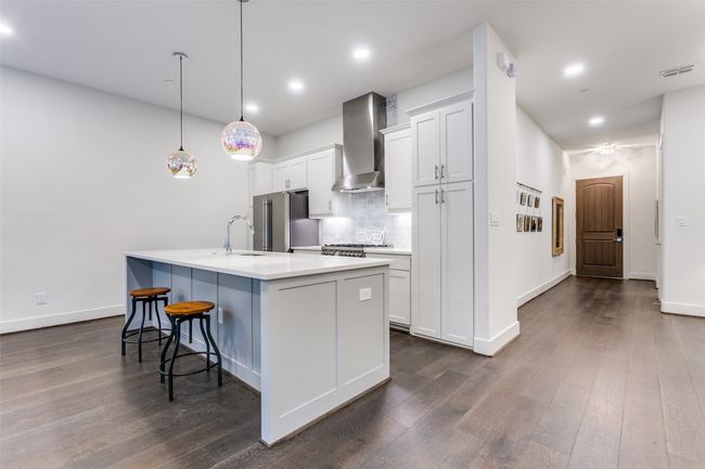 Kitchen bar with plenty of space for company and beautiful designer pendants! | Image 8