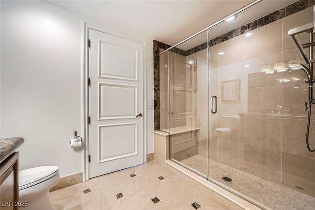 Bathroom featuring toilet, a shower stall, vanity, tile patterned flooring, and baseboards | Image 24