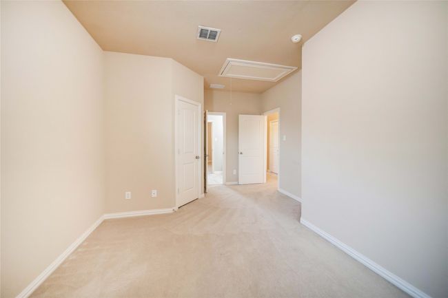 Empty room featuring attic access and light colored carpet | Image 30