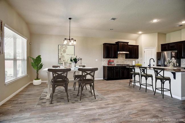 Dining room with light wood-style floors, a chandelier, recessed lighting, and vaulted ceiling | Image 5
