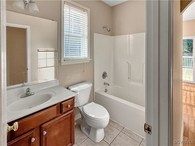 Full bath featuring vanity, shower / bathtub combination, and tile patterned flooring | Image 11