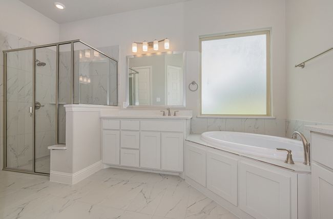 Full bath featuring a marble finish shower, a bath, marble finish floors, and vanity | Image 13