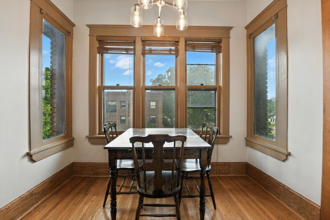 Beautiful corner dining nook with three walls of windows, flooding the space with light and providing neighborhood views. | Image 18
