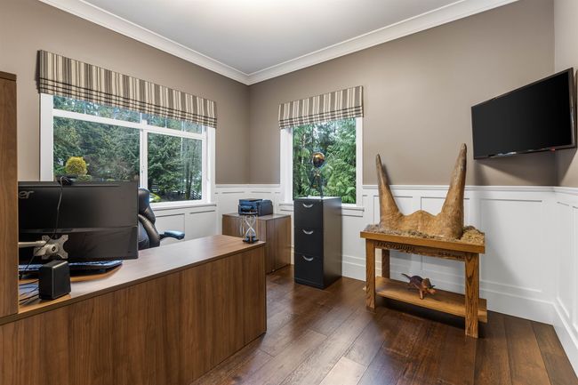 Office space with a wainscoted wall, dark wood finished floors, and crown molding | Image 15