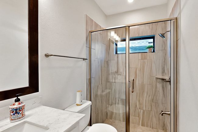Full bath featuring a stall shower, toilet, and vanity | Image 30