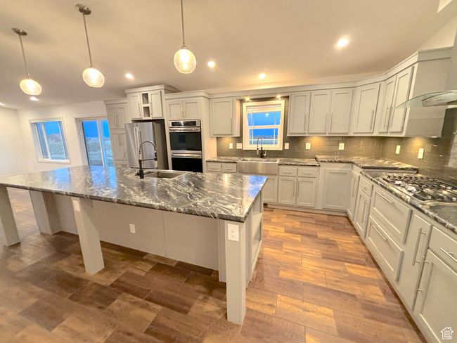 Note the gas stove, double over, pot filler over stove, prep and standard sink. | Image 5