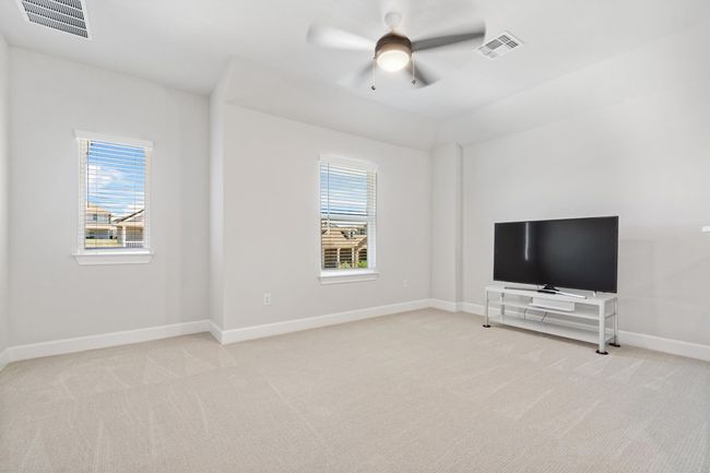 Unfurnished living room featuring light carpet, plenty of natural light, and baseboards | Image 18