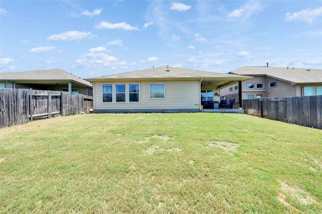 Back of house with a fenced backyard | Image 26