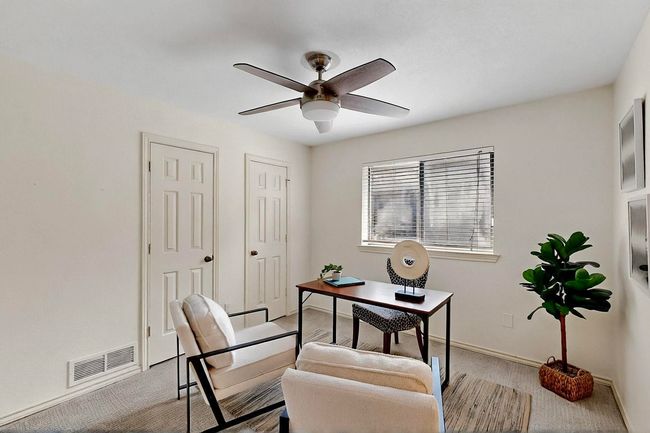 Carpeted home office with a ceiling fan and baseboards | Image 33