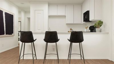 Bar with light wood-type flooring and white cabinetry | Image 2