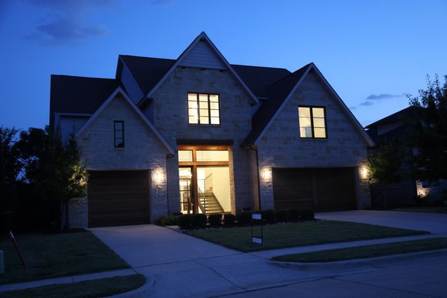 View of front of house featuring a garage, concrete driveway, and stone siding | Image 38