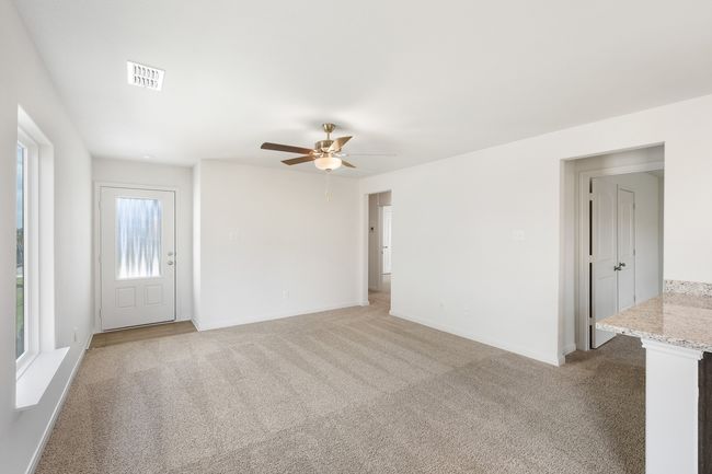 Living room with light carpet and ceiling fan | Image 4
