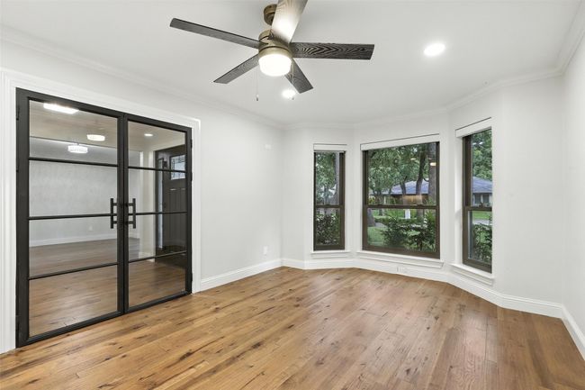 Unfurnished room featuring wood-type flooring, ceiling fan, crown molding, and recessed lighting | Image 20