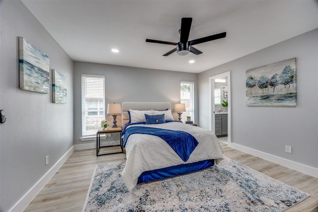 Bedroom featuring light wood finished floors, ensuite bath, recessed lighting, and a ceiling fan | Image 20