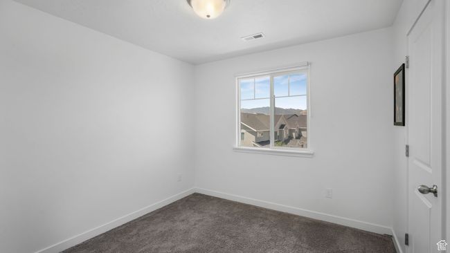 Unfurnished room with dark carpet and baseboards | Image 16