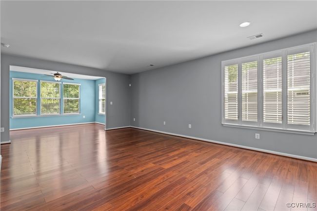 Spare room with wood finished floors, a ceiling fan, and recessed lighting | Image 9