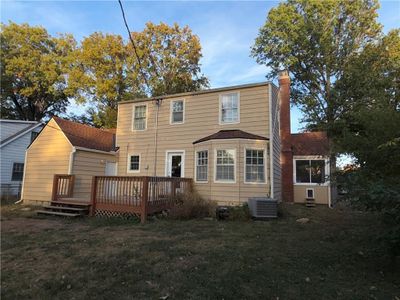 Rear view of property featuring a yard, cooling unit, and a wooden deck | Image 3