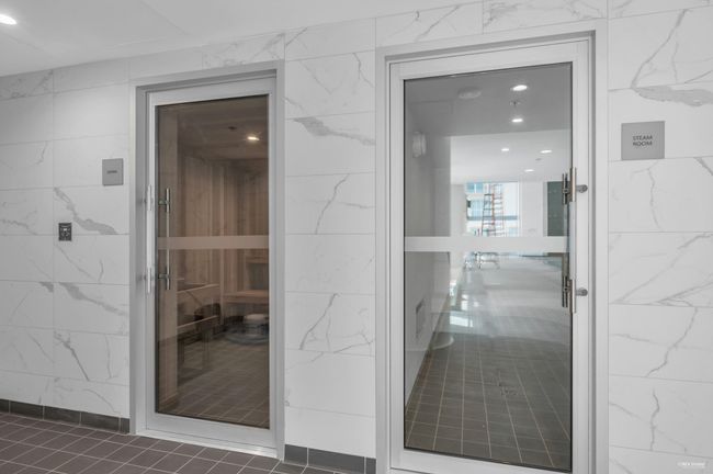 Corridor with tile walls, a relaxing sauna, and dark tile patterned flooring | Image 39