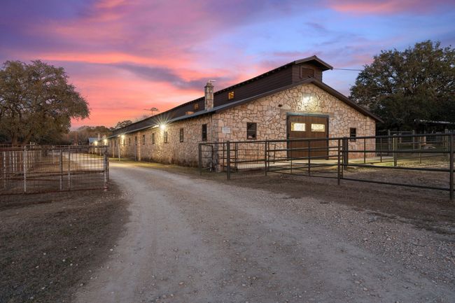 View of street featuring dirt driveway and a gated entry | Image 33