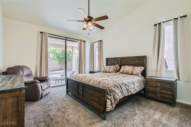Bedroom with carpet, access to exterior, vaulted ceiling, and a ceiling fan | Image 22