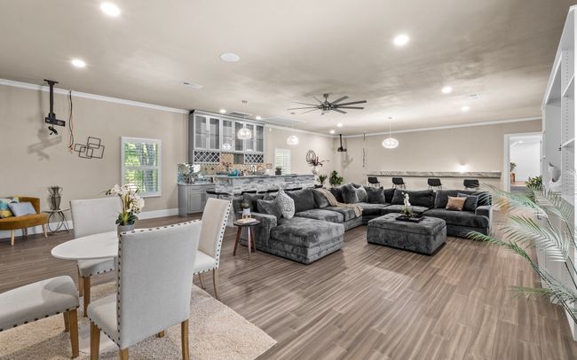 Living room with recessed lighting, ceiling fan, crown molding, and light wood-style floors | Image 22