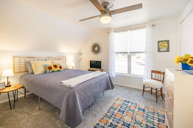 Carpeted bedroom with baseboards, ceiling fan, and lofted ceiling | Image 15