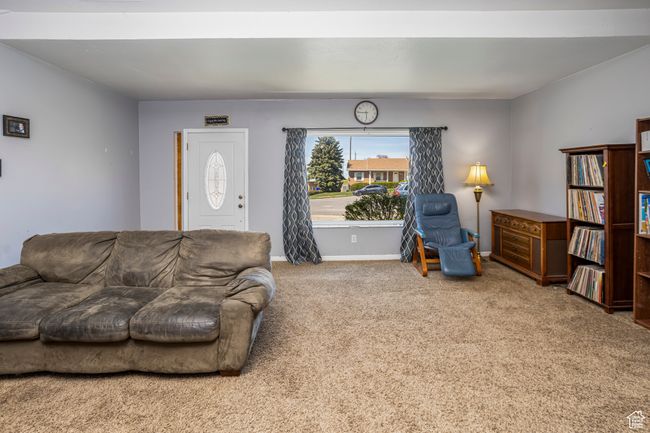 Carpeted living area with baseboards | Image 15